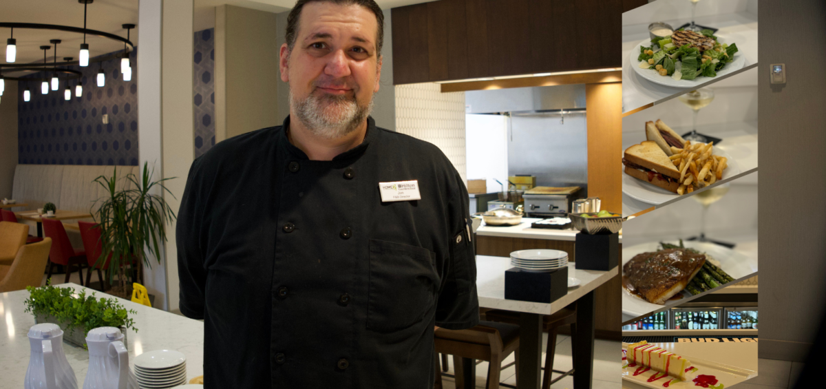 a man standing in a kitchen next to a counter